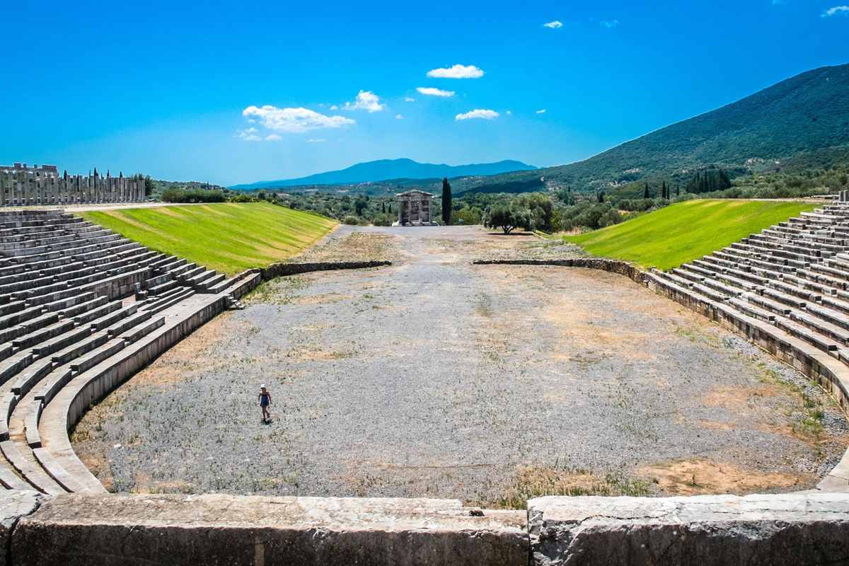 The stone stands and track of the ancient stadium of Messene in a green valley, a highlight of an Ancient Messene tour