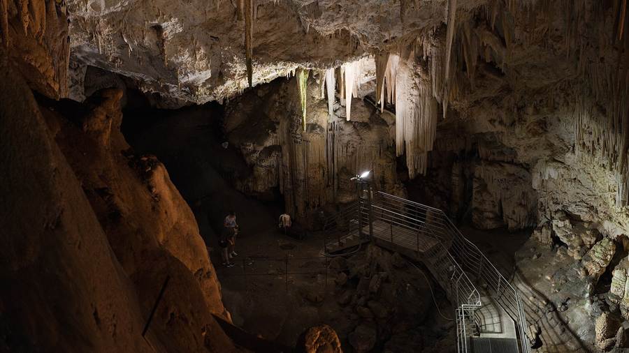 Stalactites and the visitor walkway inside the Antiparos Cave