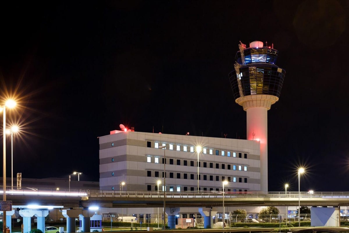 The control tower of Athens International Airport lit at night on an Athens airport transfer