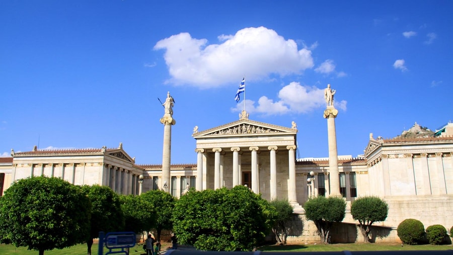 The Academy of Athens with its two tall columns on an Athens hop on hop off route