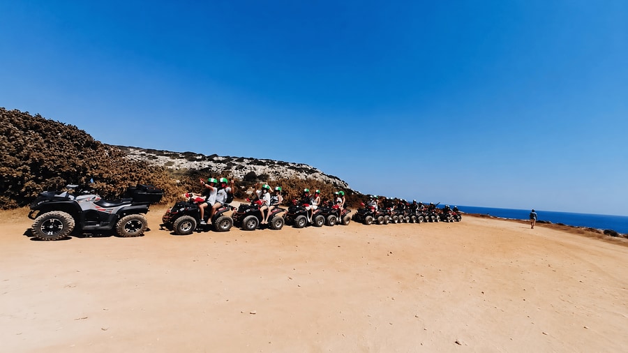 Line of quad bikes parked on a clifftop beside the sea on an Ayia Napa quad safari