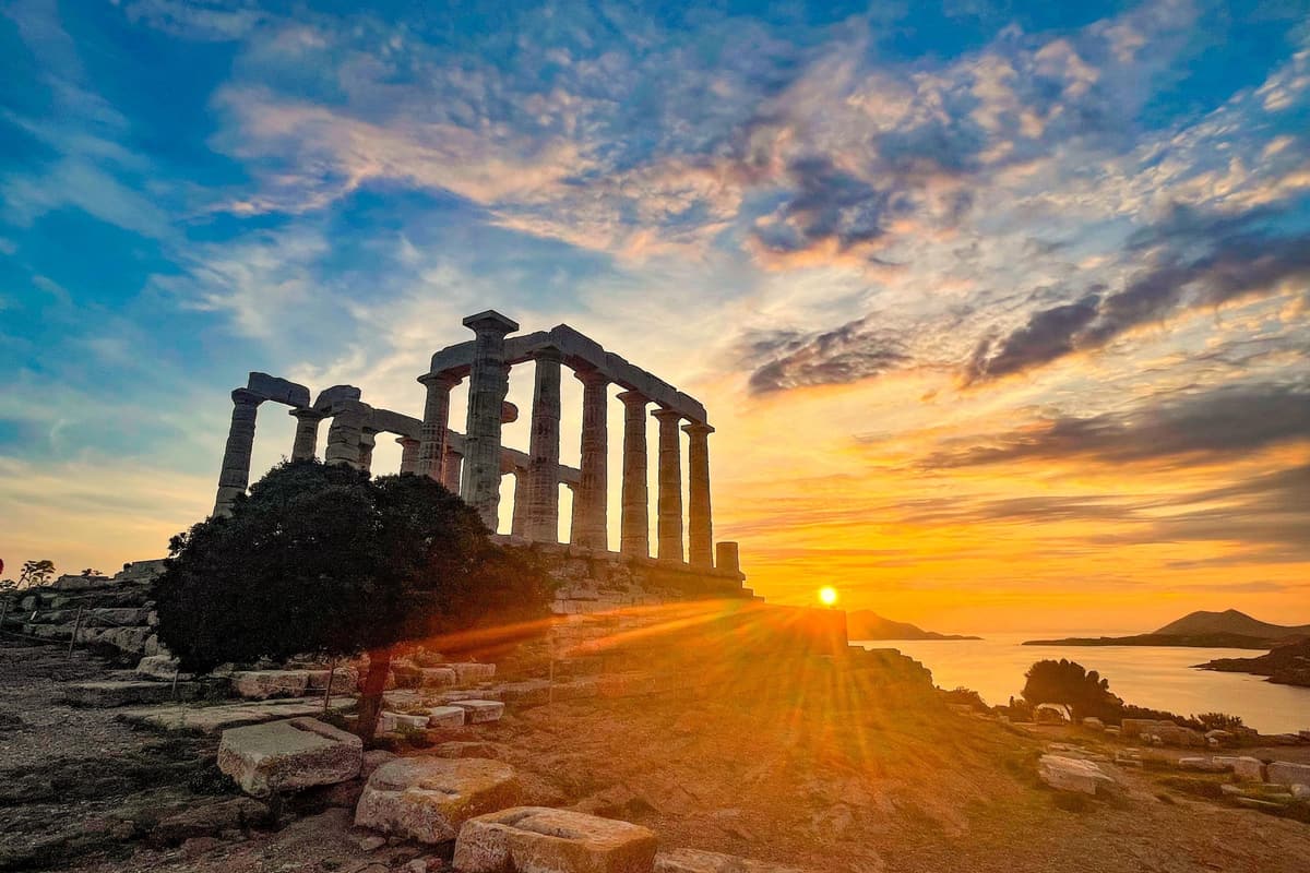 The Temple of Poseidon at sunset above the sea, seen on a Cape Sounion tour