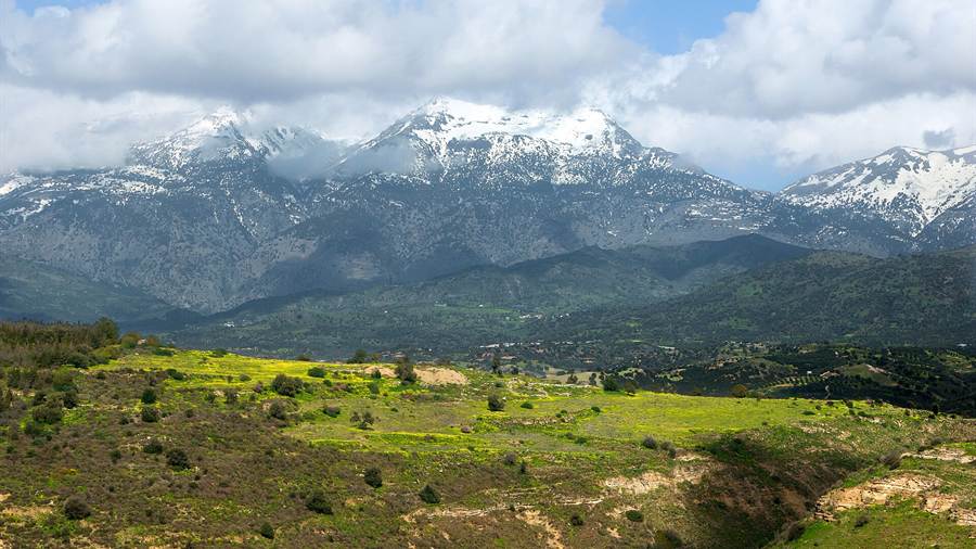 Snow on the Ida range above the green hills of south Crete, a backdrop to Crete tours