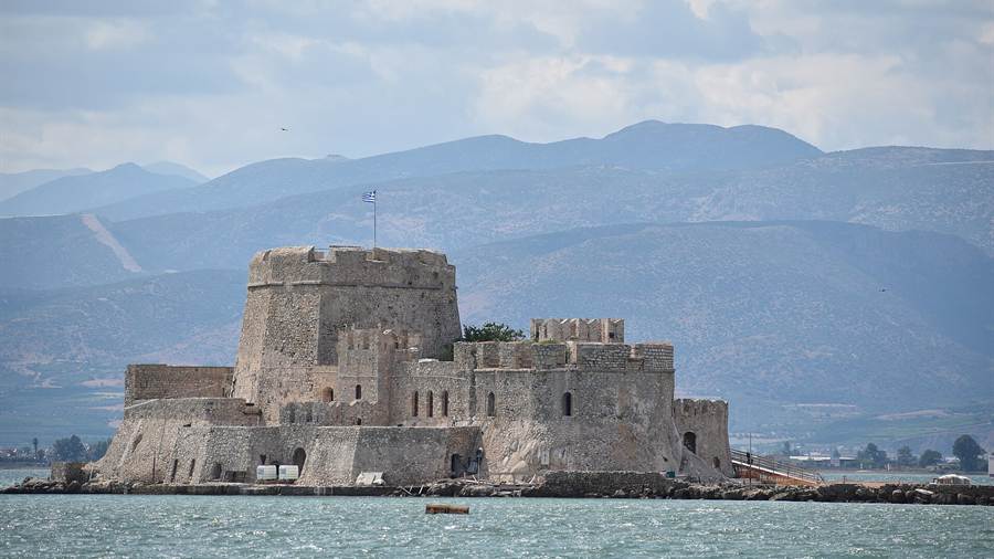 Bourtzi island fortress in the bay of Nafplio with mountains behind