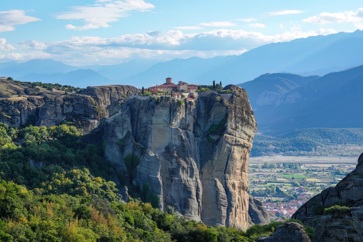 The Holy Trinity monastery on its rock pillar above Kalambaka and the plain, seen on a Delphi Meteora tour