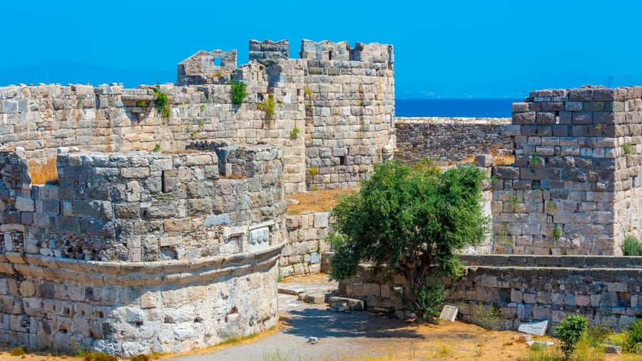 The stone towers and walls of the Neratzia castle of the Knights in Kos town on a Kos island tour