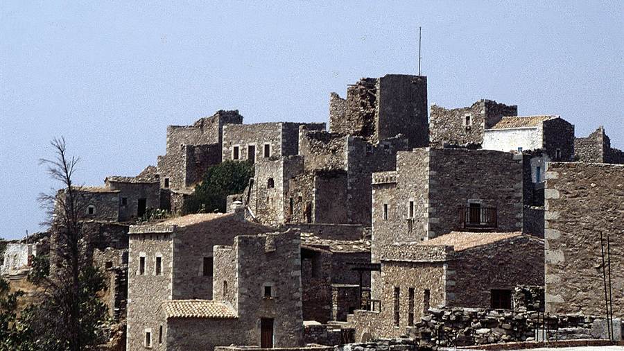 Close view of stone tower houses in the village of Vatheia