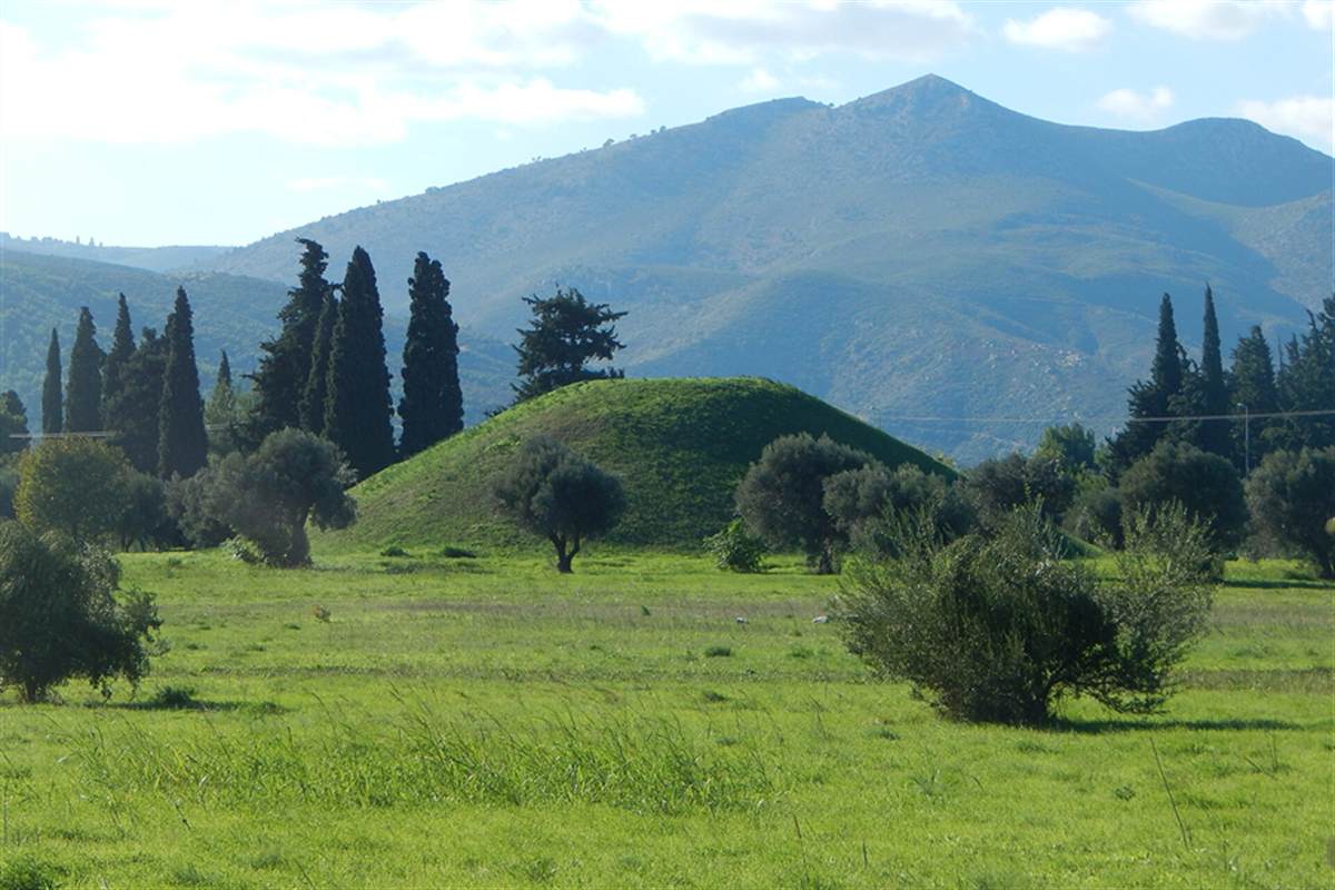Grass-covered burial mound near Marathon with cypress trees and a mountain behind, Marathon tour