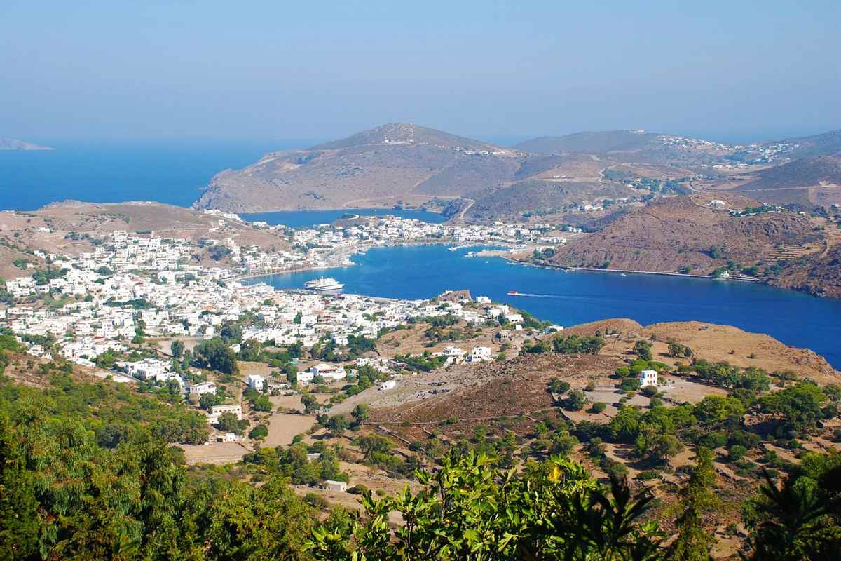 The bay and white houses of Skala on Patmos seen from the hills, the arrival point of a Patmos day trip