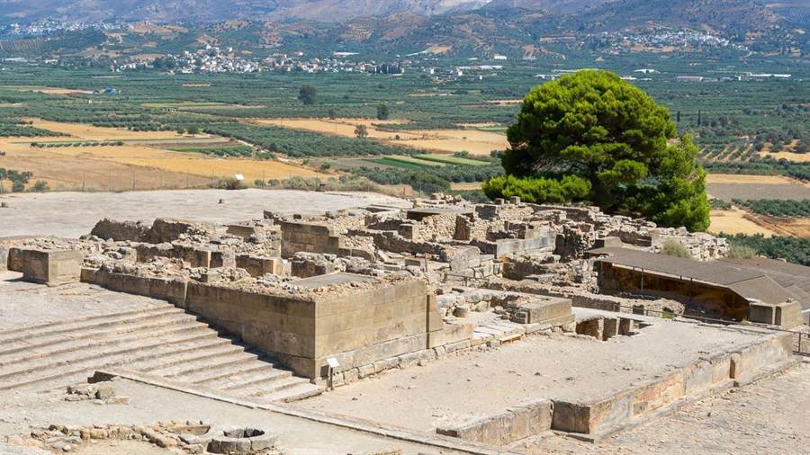 Stone foundations and courts of the Minoan palace at Phaistos with the plain behind, seen on a Phaistos tour
