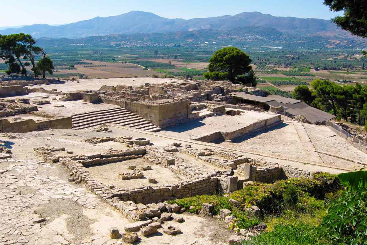 The stone ruins of the Minoan palace at Phaistos on its ridge with the Messara plain and mountains behind, the site of a Phaistos tour
