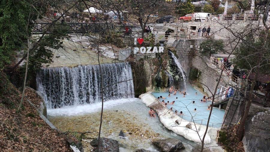 Water running over stone cascades in a wooded gorge near the Pozar thermal baths