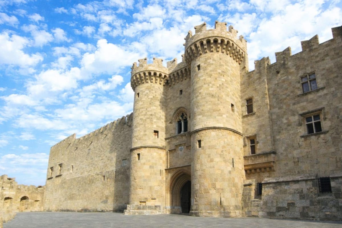 Twin round towers and arched gate of the Palace of the Grand Master on a Rhodes old town tour