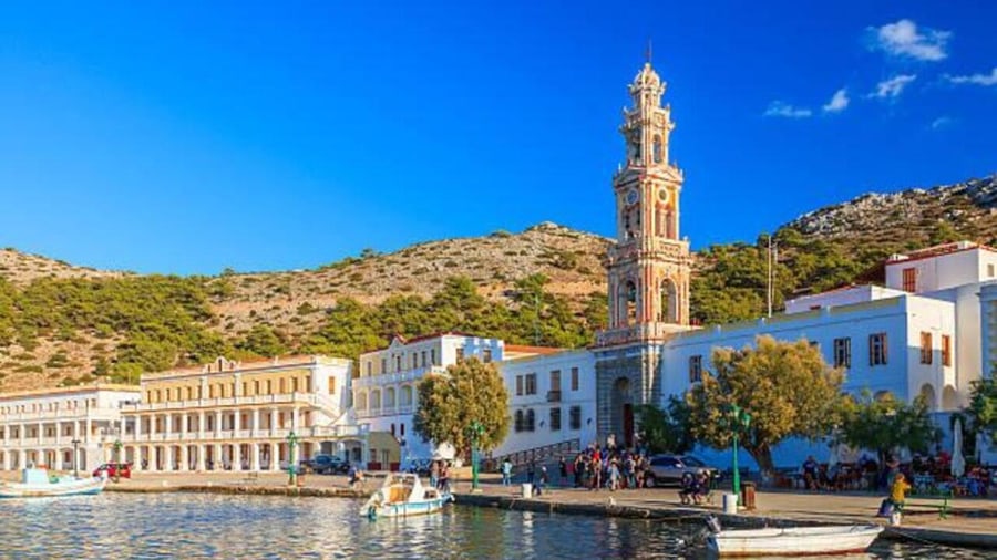 The bell tower of Panormitis monastery above the harbour, a stop on a Symi day trip from Rhodes