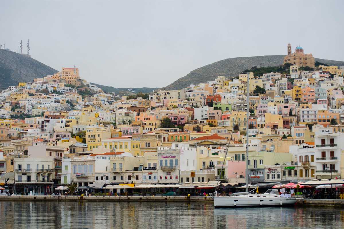 The houses of Ermoupoli climbing two hills above the harbour of Syros, the town reached on a Syros day trip