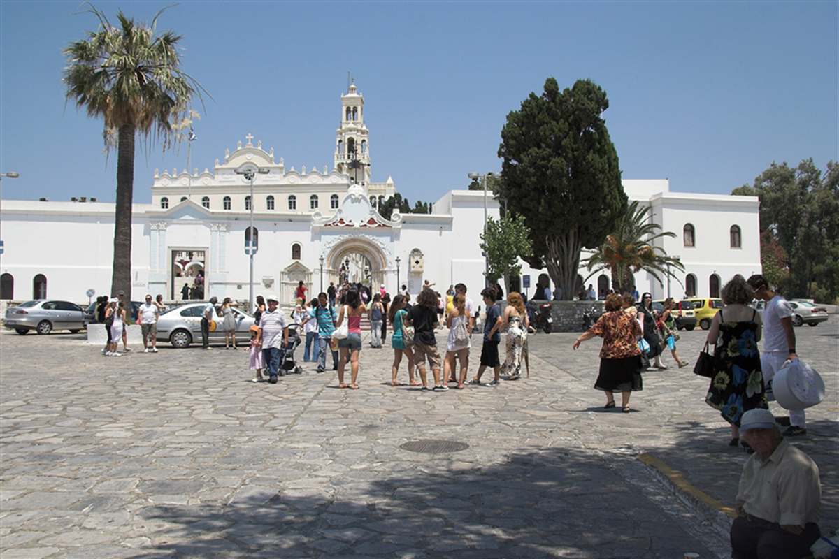 White church of Our Lady of Tinos beyond a paved square, Tinos day trip