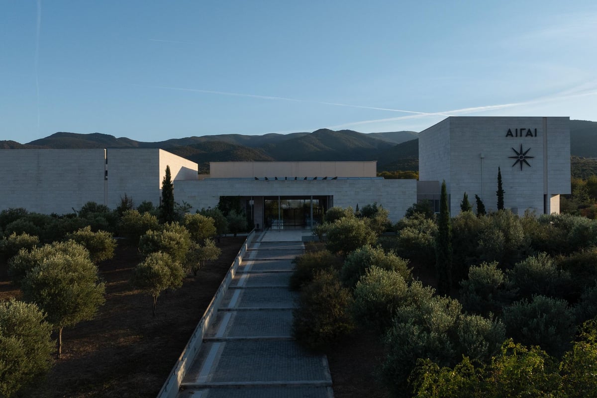 Vergina day trip highlight, the Aigai museum entrance and royal tombs complex set among olive trees below green hills