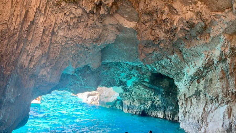 Turquoise water glowing under a rock vault in the Zakynthos blue caves